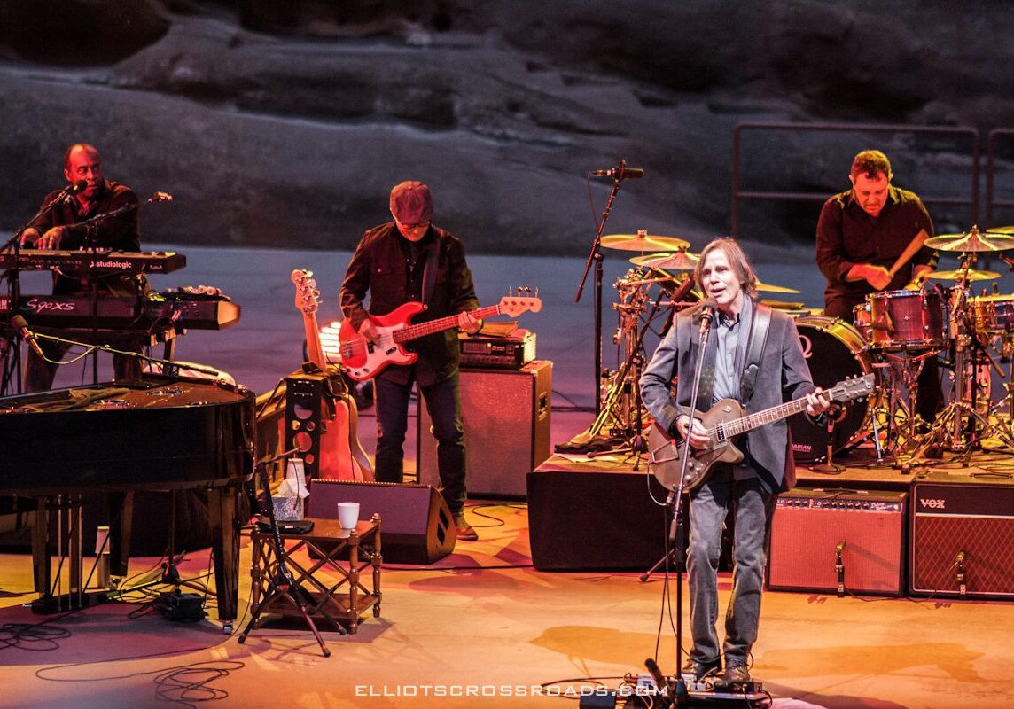 Band performing live on stage with instruments.