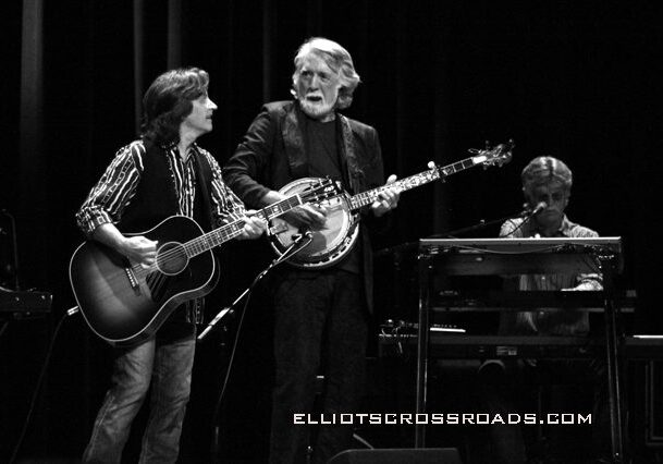 Musicians performing on stage with instruments.