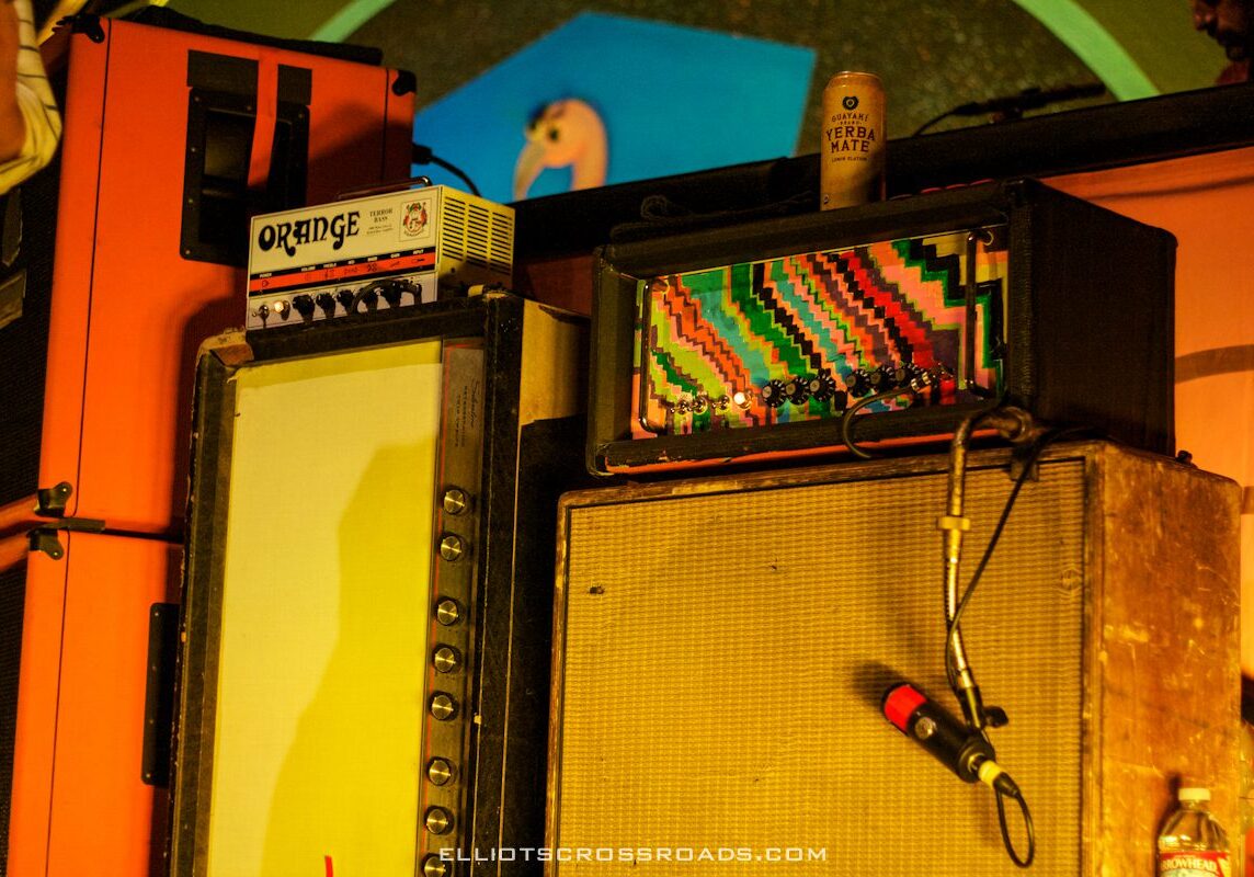 Colorful guitar amplifiers with microphone on stage.