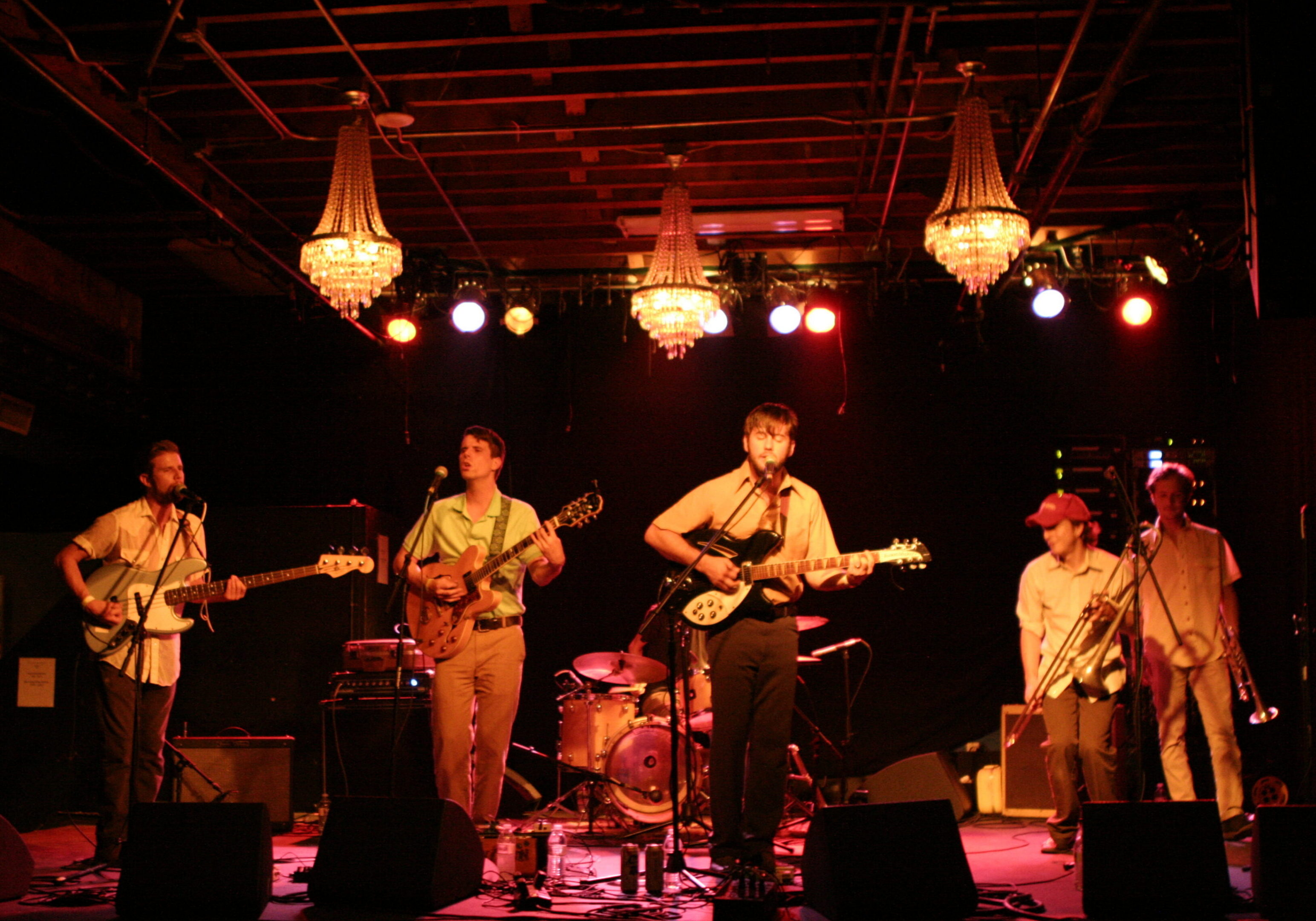 Band performing on stage with instruments.