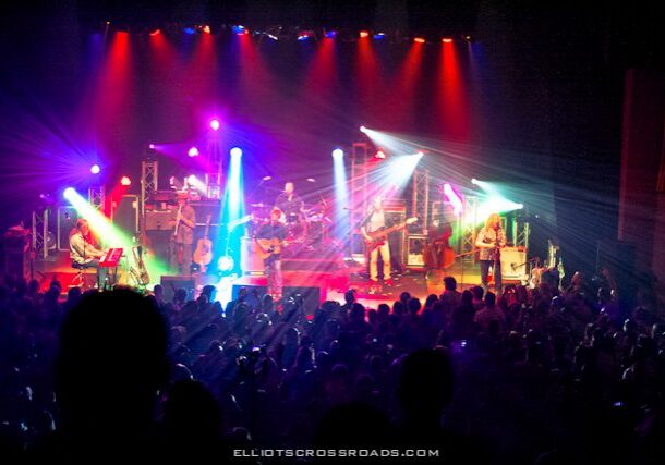 Live band performing on colorful stage.
