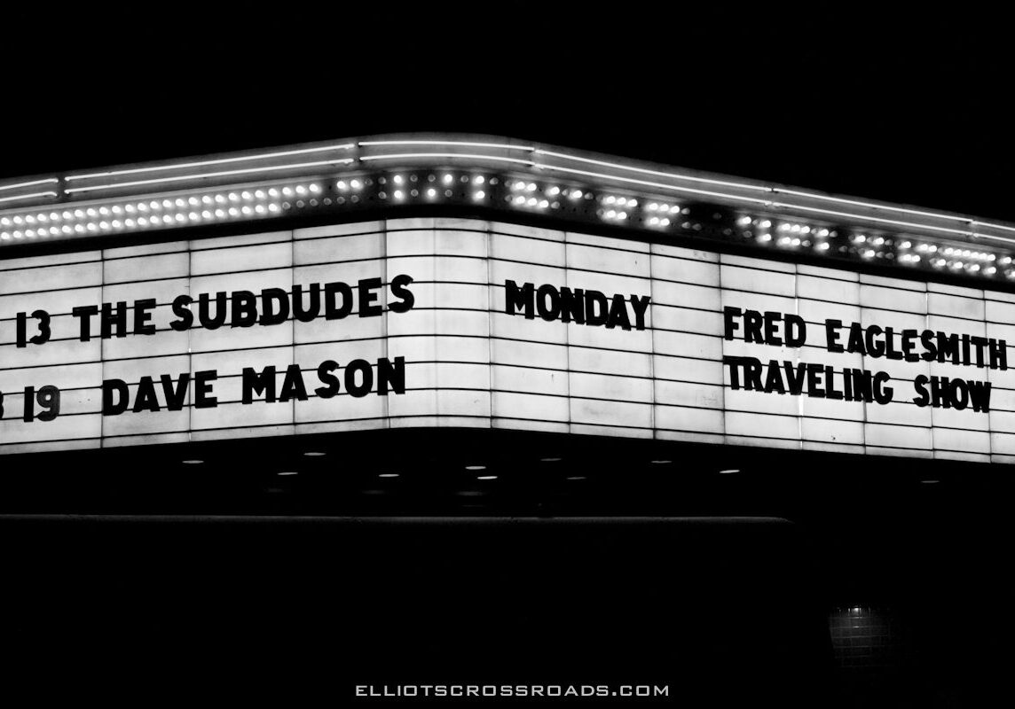 Theater marquee with upcoming concert dates listed.