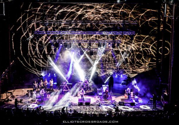 Concert stage with vibrant light show.
