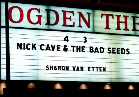 Theater marquee featuring Nick Cave concert announcement.