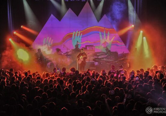 Concert with colorful lights and crowd.