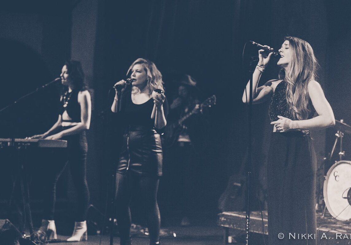 Live band performing on stage in monochrome.