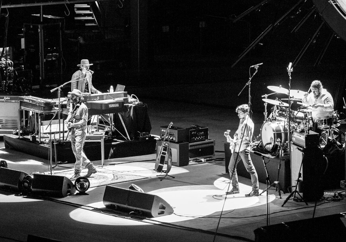 Band performing live on stage in monochrome.