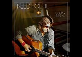 Man playing guitar on album cover.