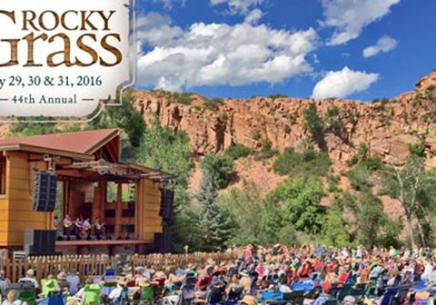 Outdoor music festival with audience and stage.