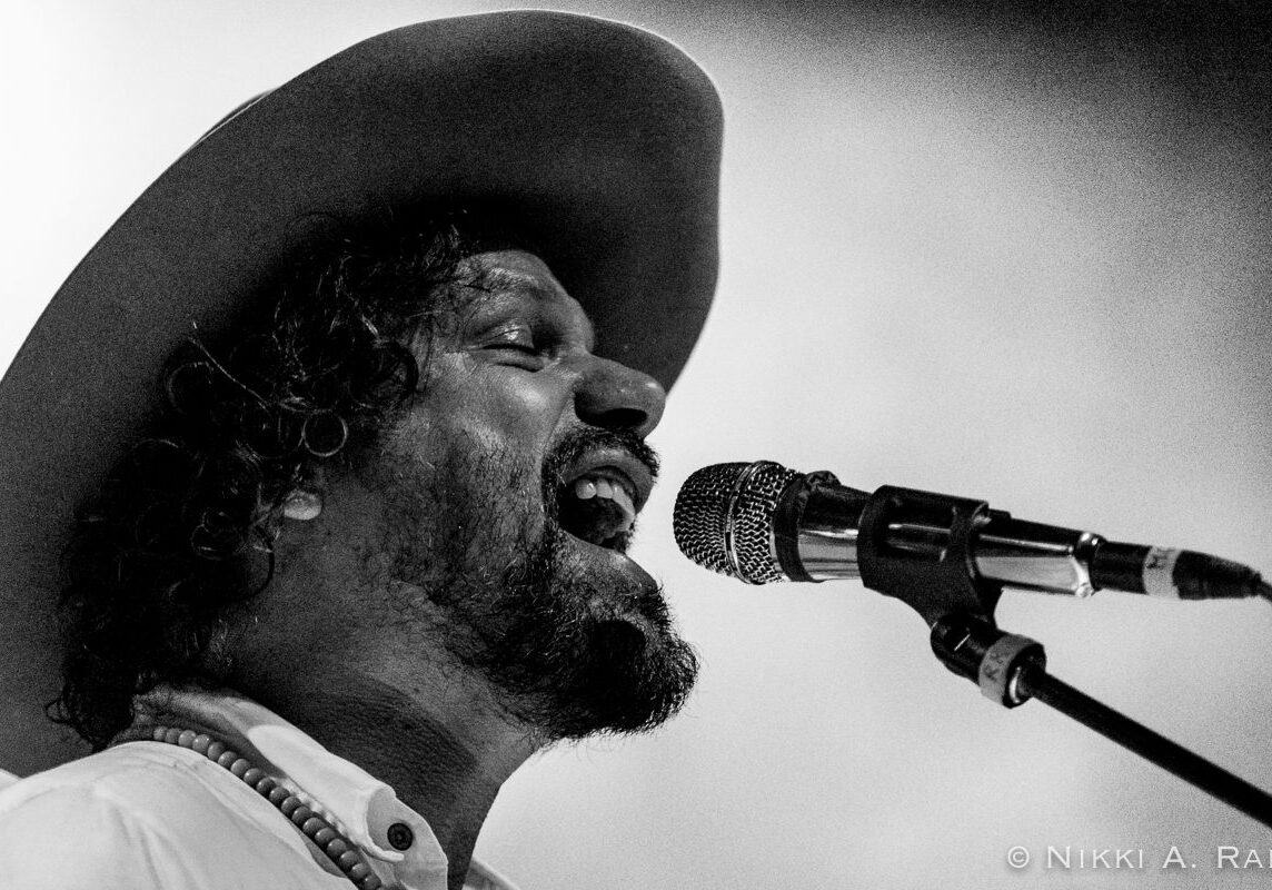 Singer performing passionately with a microphone.