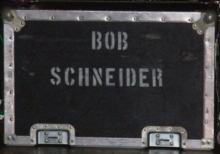 Black equipment case with "Bob Schneider" text.