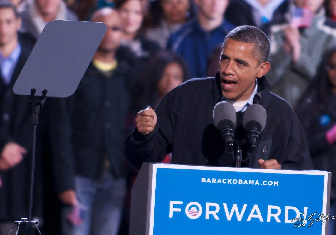 Man speaking at podium during public event.