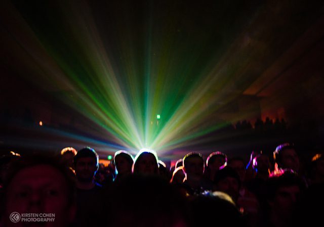 Concert crowd with colorful stage lights.