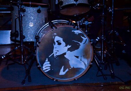 Drum set with a painted portrait.