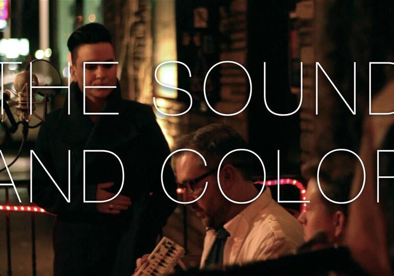 Musicians performing with text overlay.
