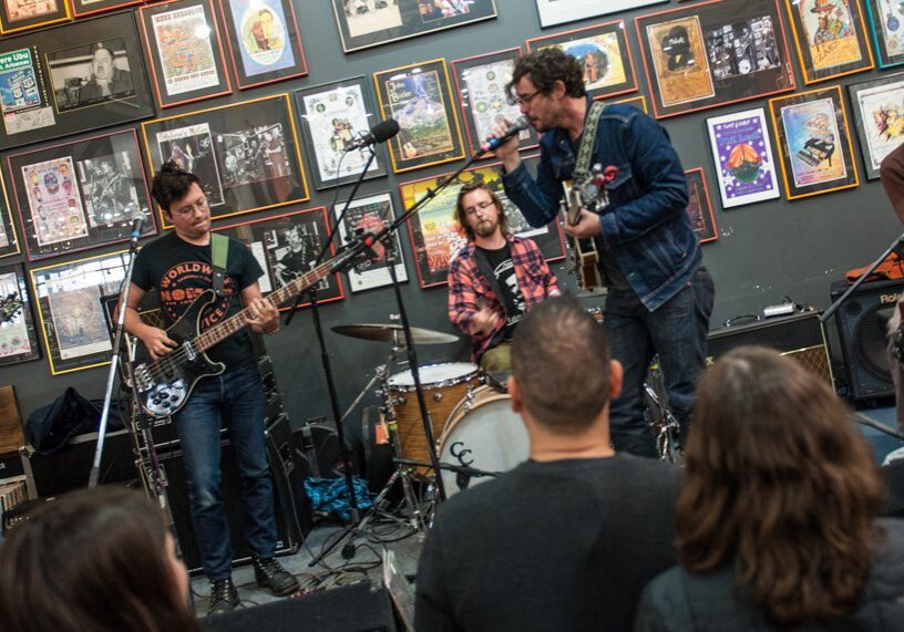 Band performing live in front of audience.