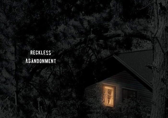 House in dark forest with glowing window.