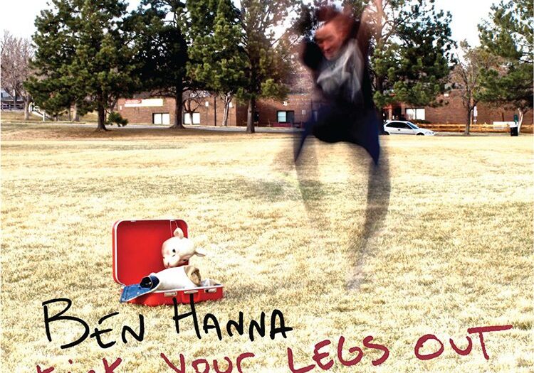 Person jumping near suitcase and teddy bear.