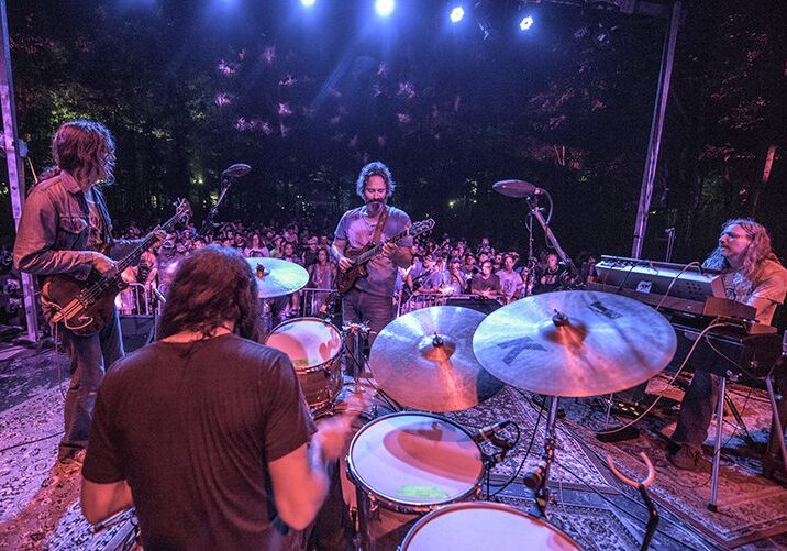 Band performing live on an outdoor stage.