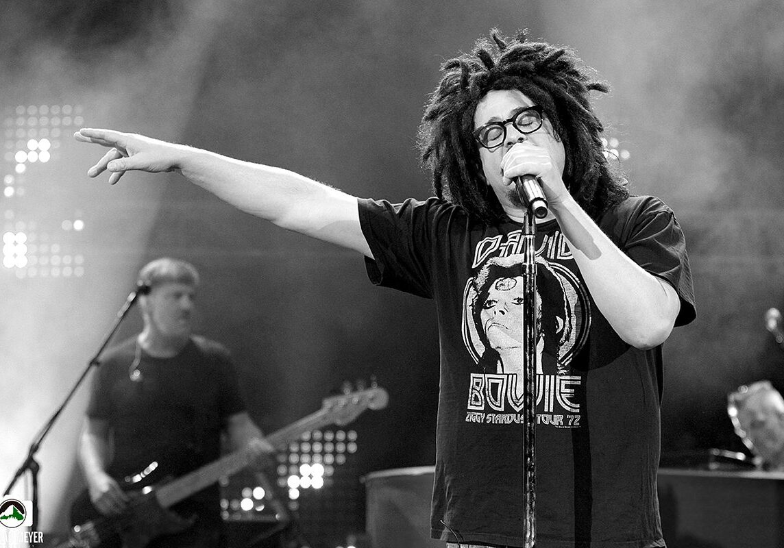 Singer performing on stage with microphone.