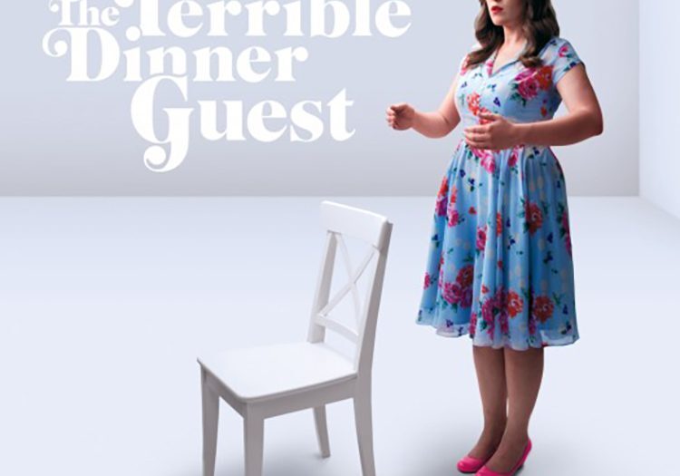 Woman in floral dress beside empty chair.