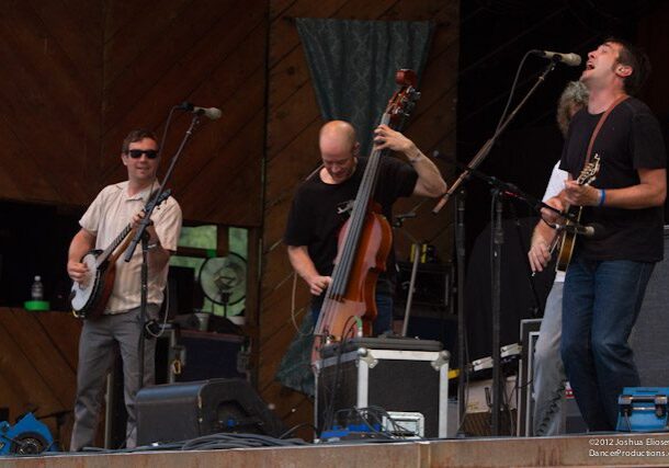 Band performing on stage with instruments.