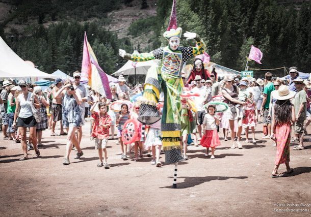 Festival crowd with person on stilts.