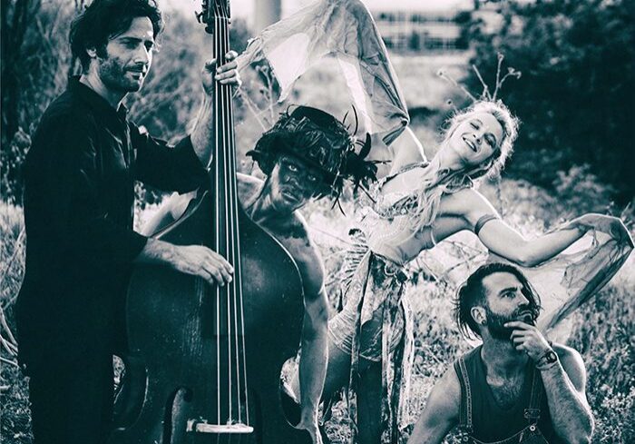 People posing creatively with musical instruments outdoors.