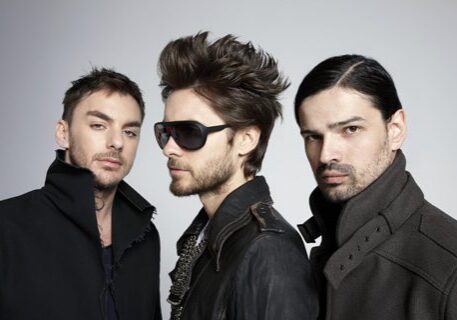 Three men in stylish black clothing.