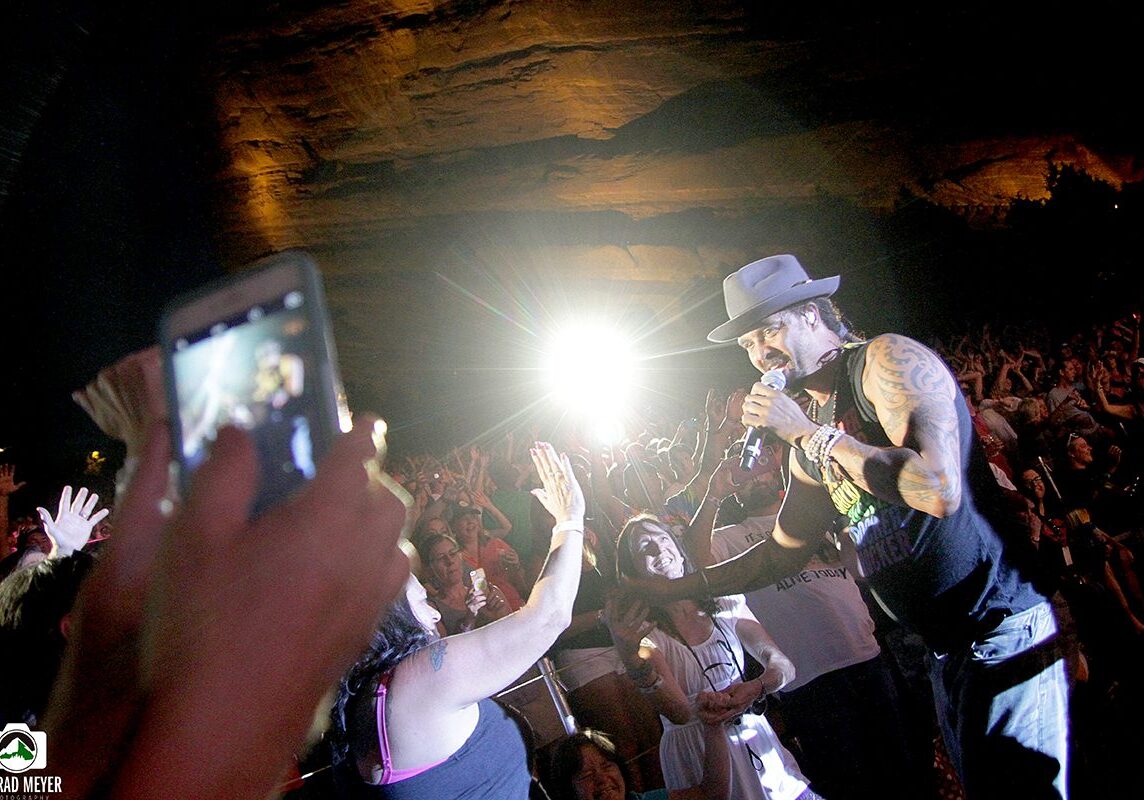 Performer engaging with audience at concert.