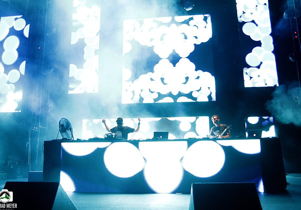 DJ performance with vibrant stage visuals.