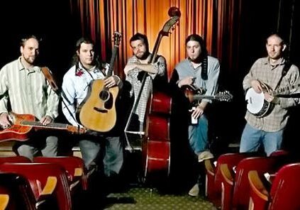 Band with instruments in a theater setting.