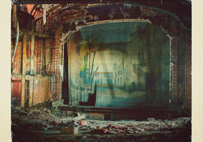 Ruined theater with "Head for the Hills.