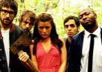 Group of people in forest holding axe.