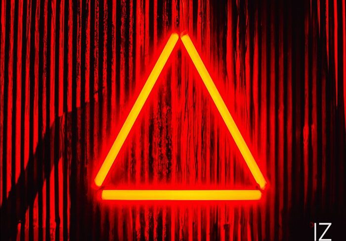 Red neon triangle on striped background.