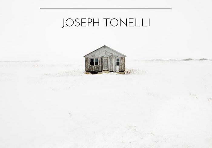 Small house in snowy landscape, minimalist design.