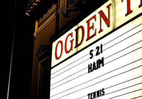 Theater marquee with concert dates displayed.
