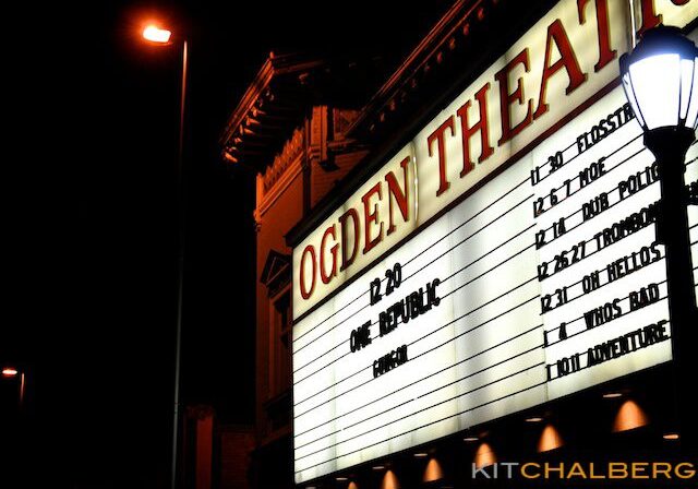 Ogden Theatre marquee at night with listings.