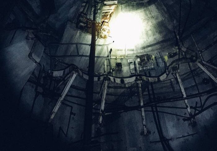 Dark industrial scene with bright overhead light.