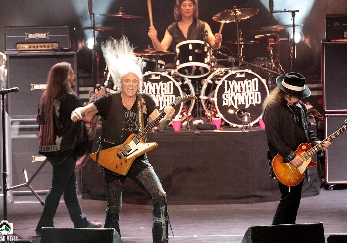 Band performing live on stage with guitars.