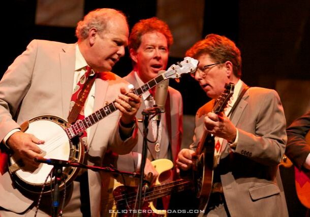 Musicians performing on stage with instruments.