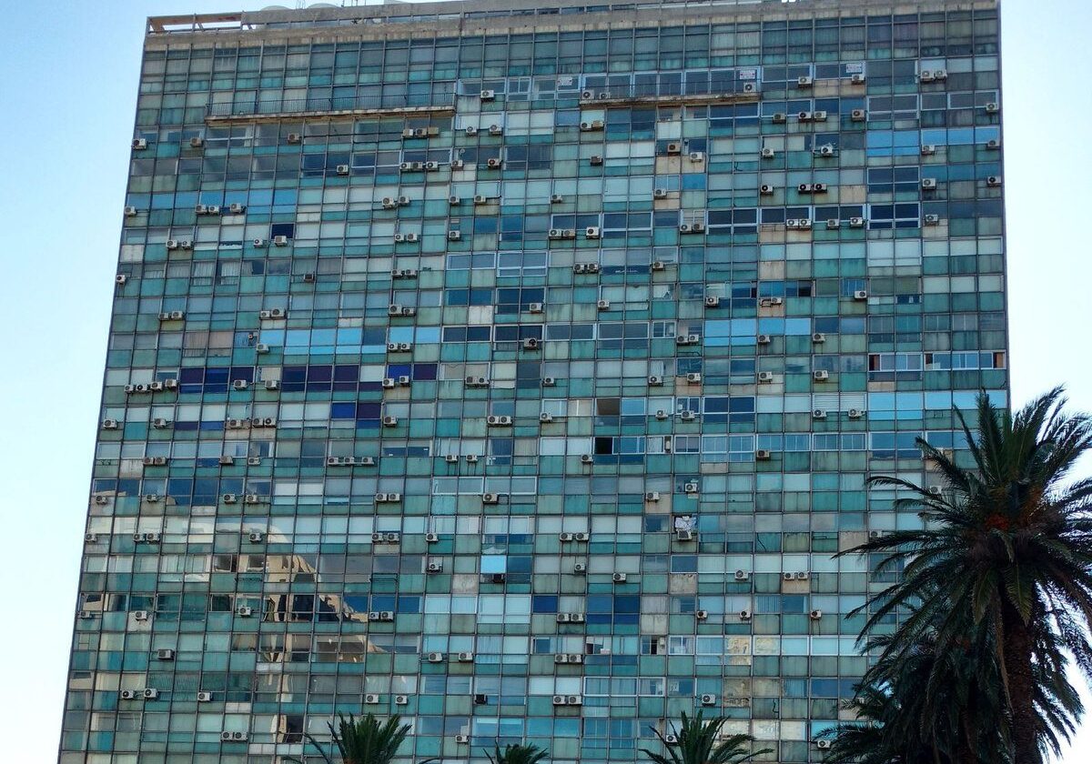 Tall building with blue glass windows.