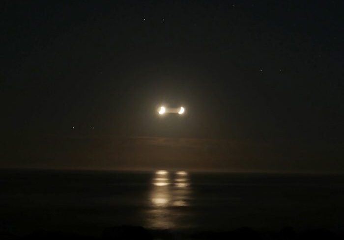 Dark ocean with mysterious glowing lights.