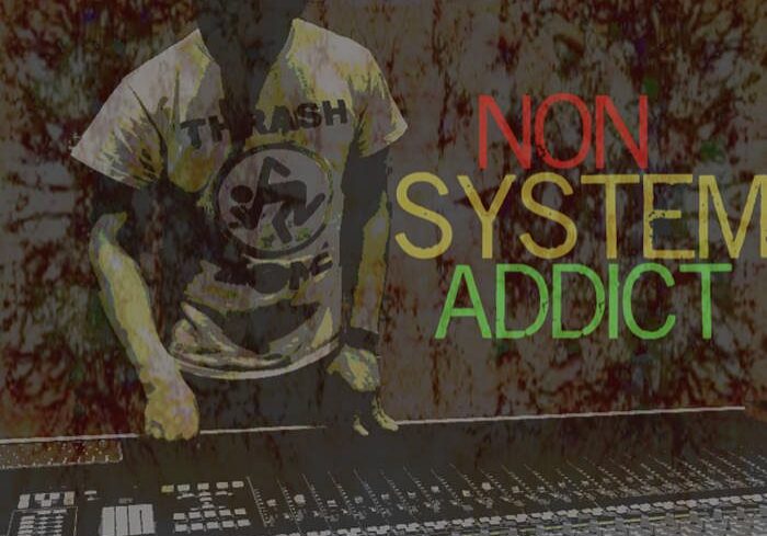 Person at mixing console, "Non System Addict".