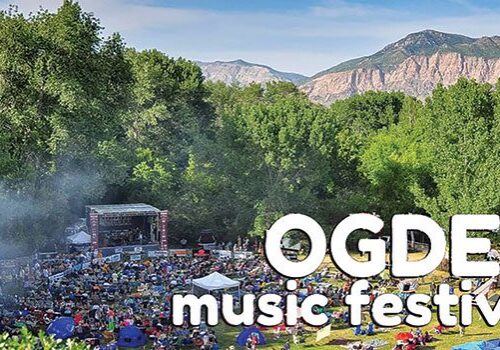 Outdoor music festival with mountain backdrop.