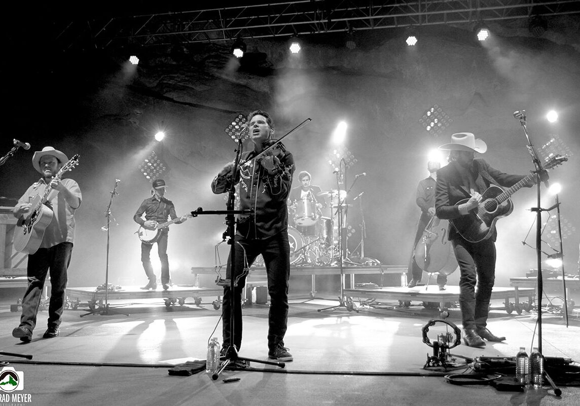 Band performing live on stage, black-and-white.