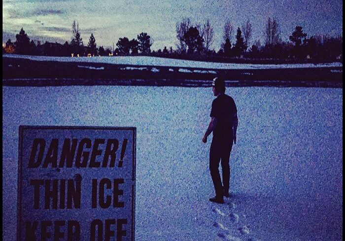 Person walking on thin ice at dusk.