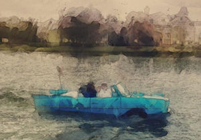 Couple in blue car on water.
