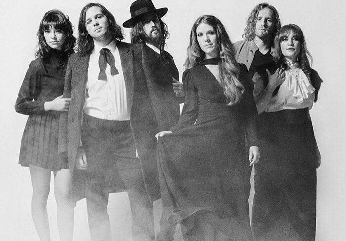 Group of six people in vintage clothing.
