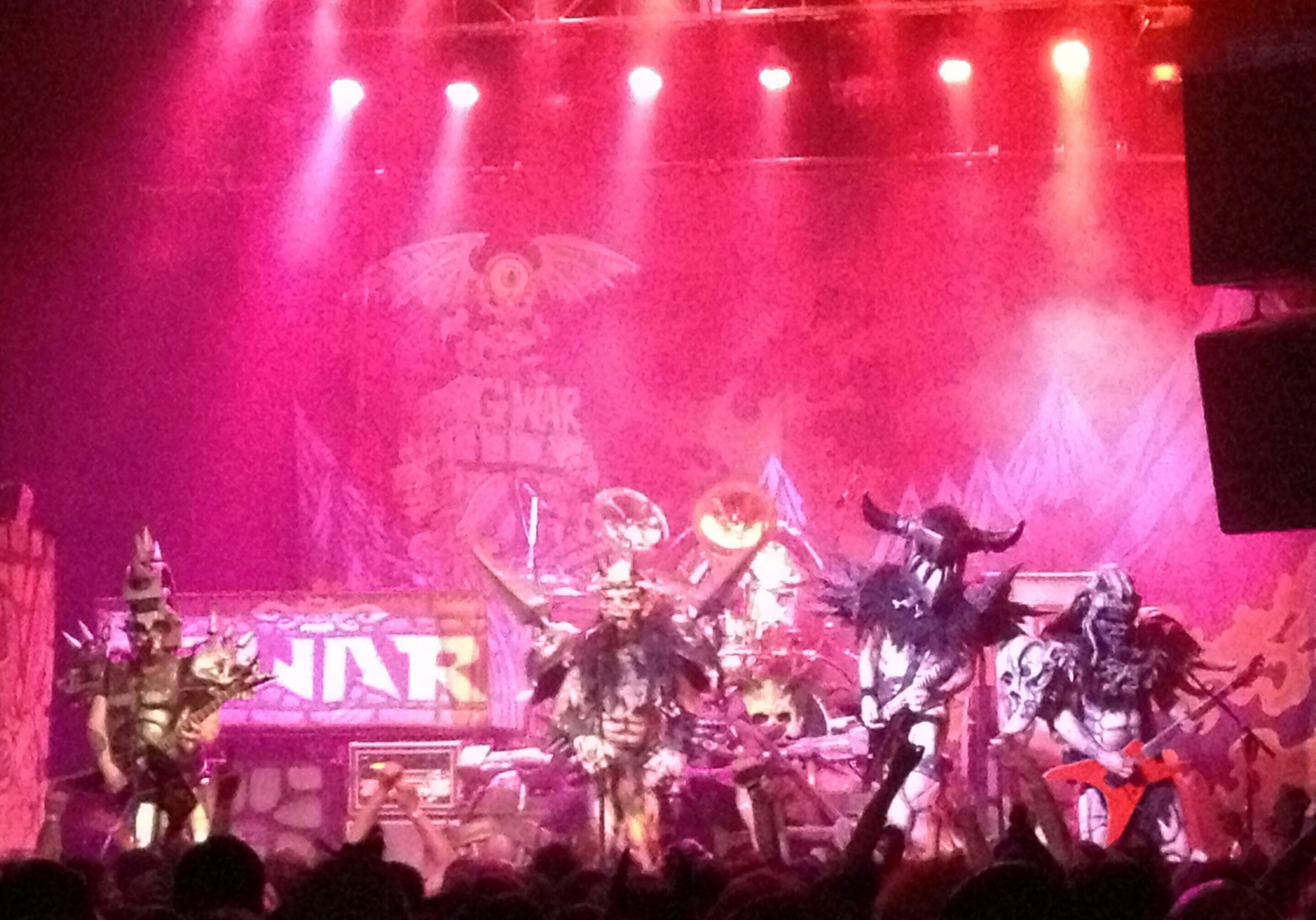 Band performing on stage with vibrant lighting.